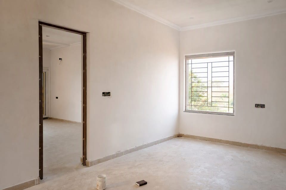 A room with smooth puttied white walls, ready for primer and paint