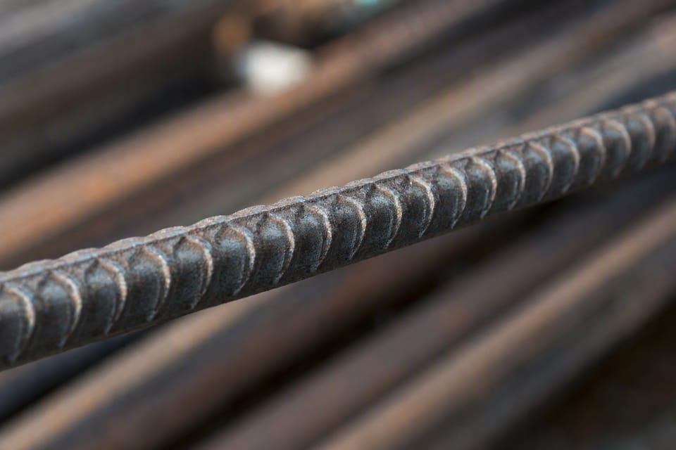 A close view of the ribbed surface of a steel reinforcement bar